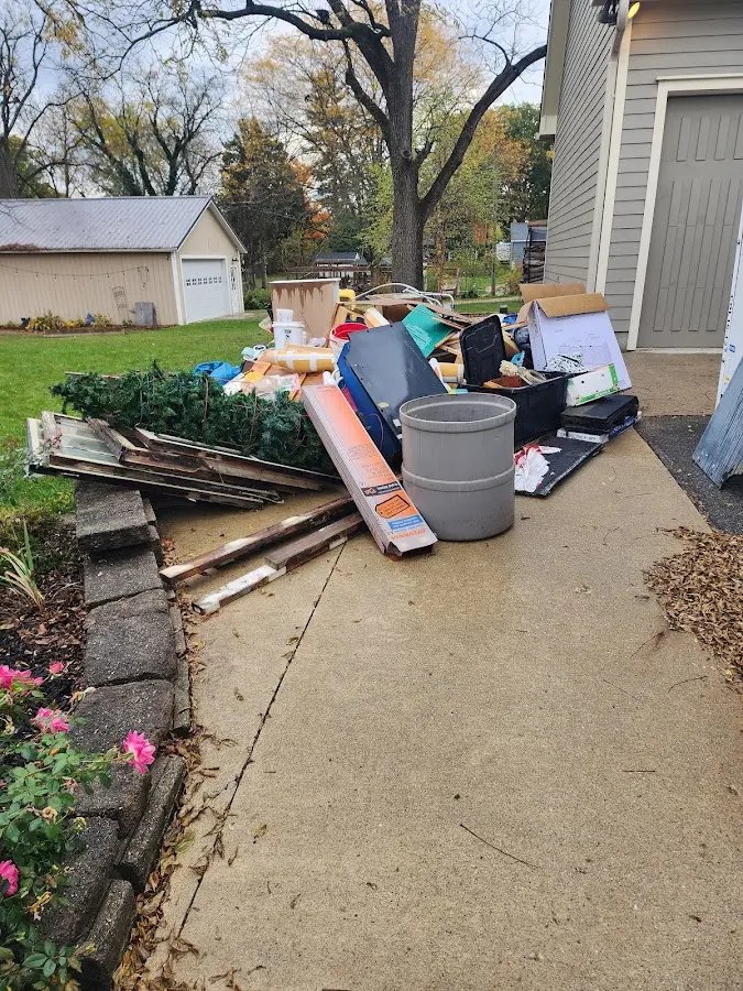 Dumpster being loaded with debris for 3 Yard Dumpster Rental in South St. Paul